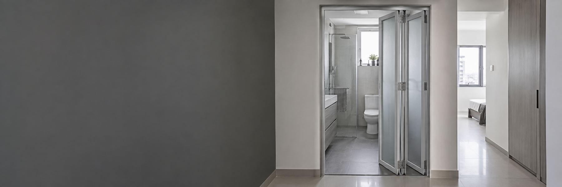 Space-saving aluminium bi-fold doors in a Singapore apartment